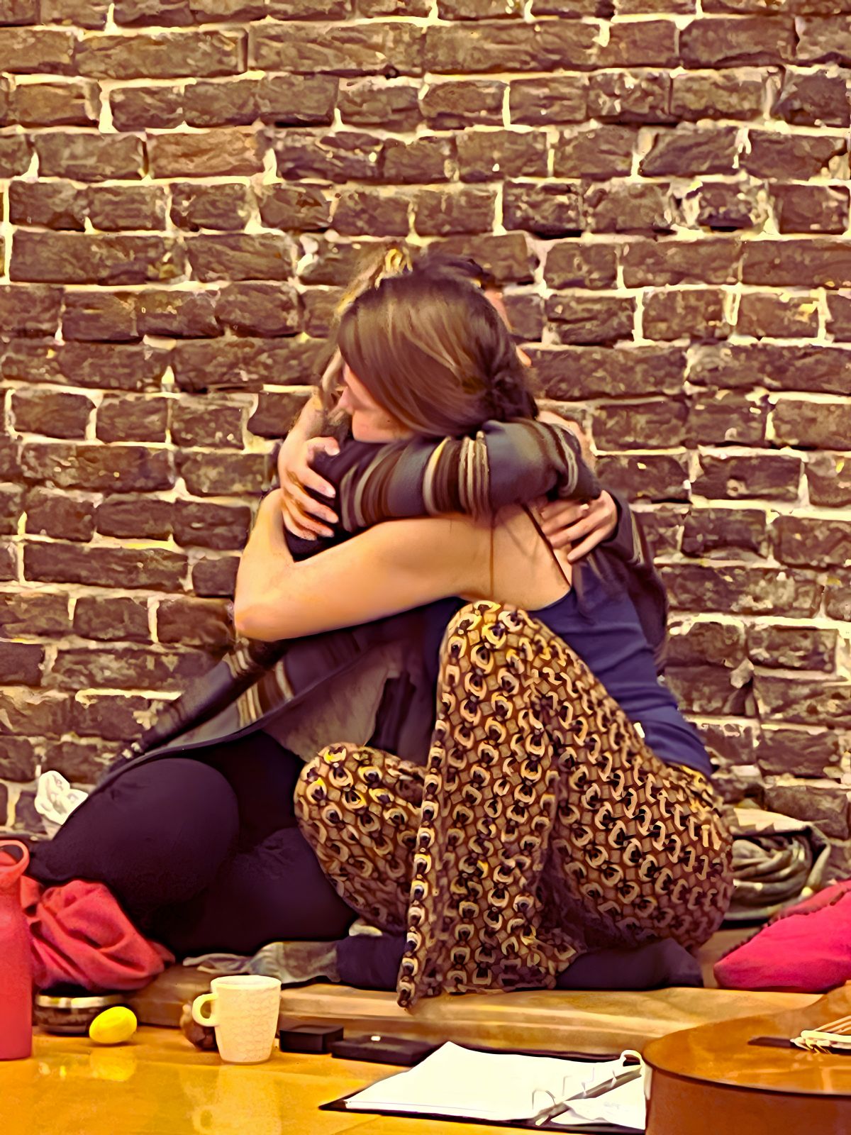 Two participants embracing after a singing circle